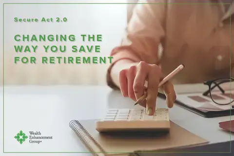 Closeup of a person's hand on a calculator as they do their taxes. In green, the words "Secure Act 2.0 Changing the Way You Save for Retirement" are superimposed over the image.
